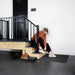 Carbon flake epoxy floor with seating area and black railing – slip-resistant matte finish.