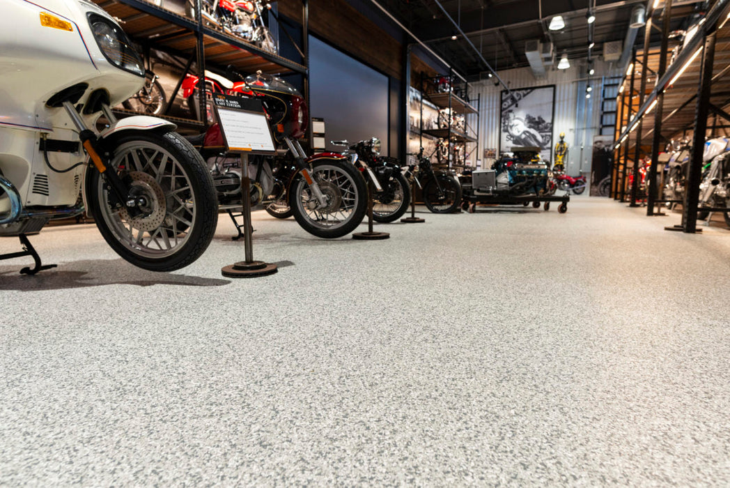 Detailed view of installed Silver Bells epoxy flooring, highlighting gray and white flake pattern.