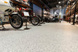 Detailed view of installed Silver Bells epoxy flooring, highlighting gray and white flake pattern.